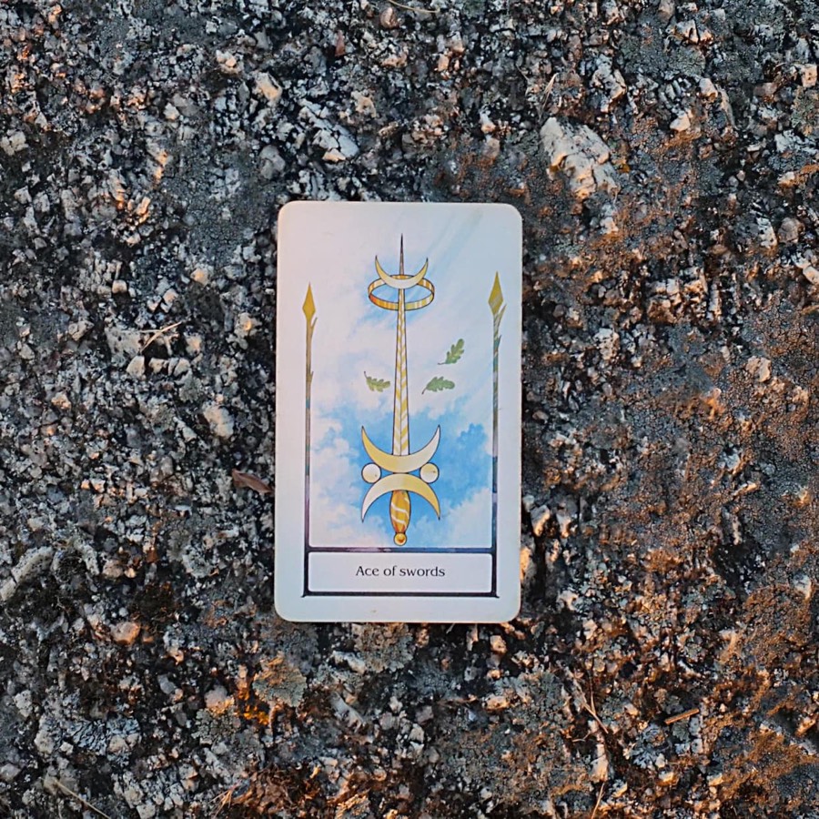 The Ace of Swords tarot card photographed outdoors