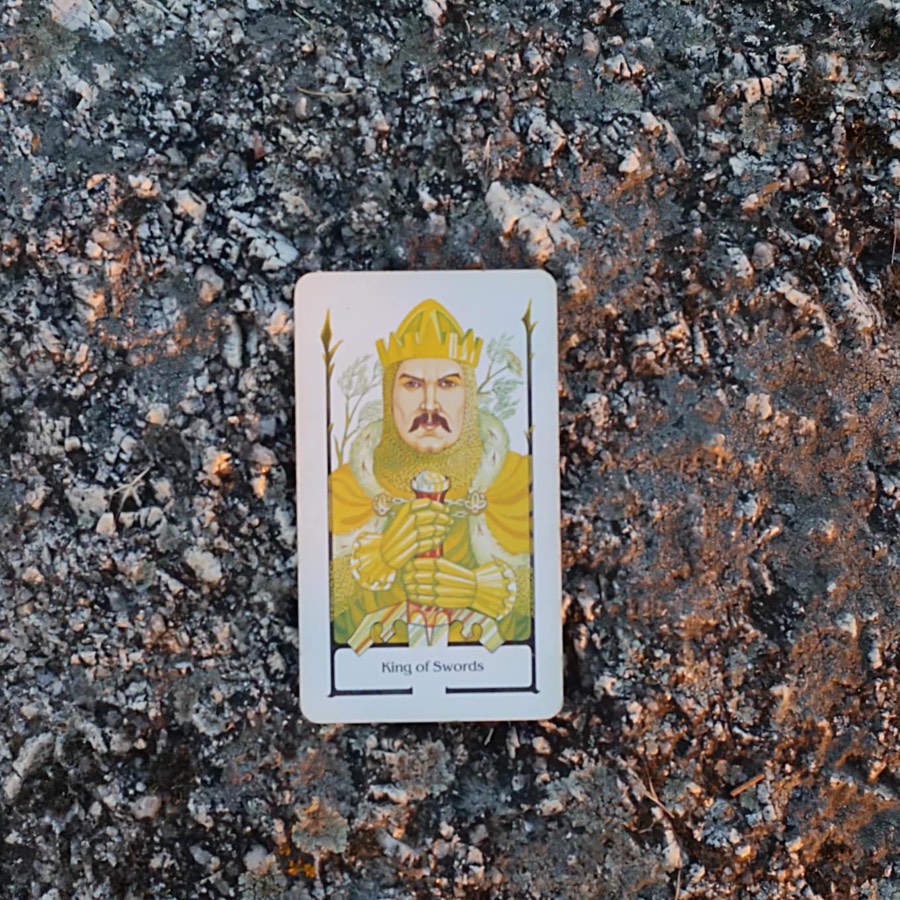 The King of Swords tarot card photographed outdoors