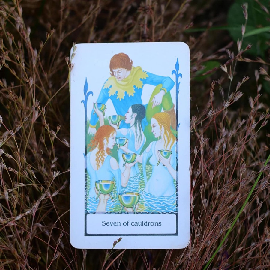 The Seven of Cups tarot card photographed outdoors