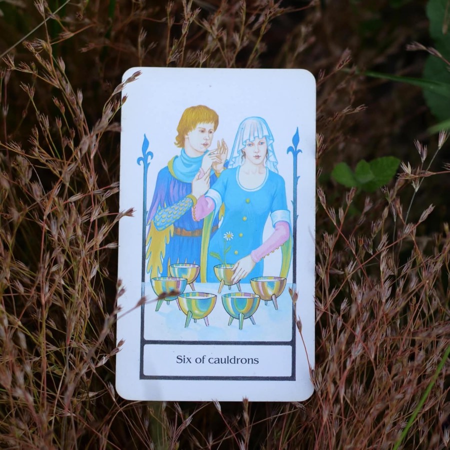 The Six of Cups tarot card photographed outdoors