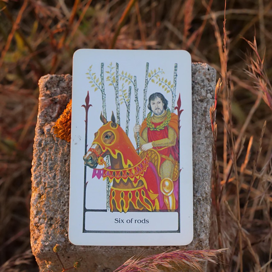 The Six of Wands tarot card photographed outdoors
