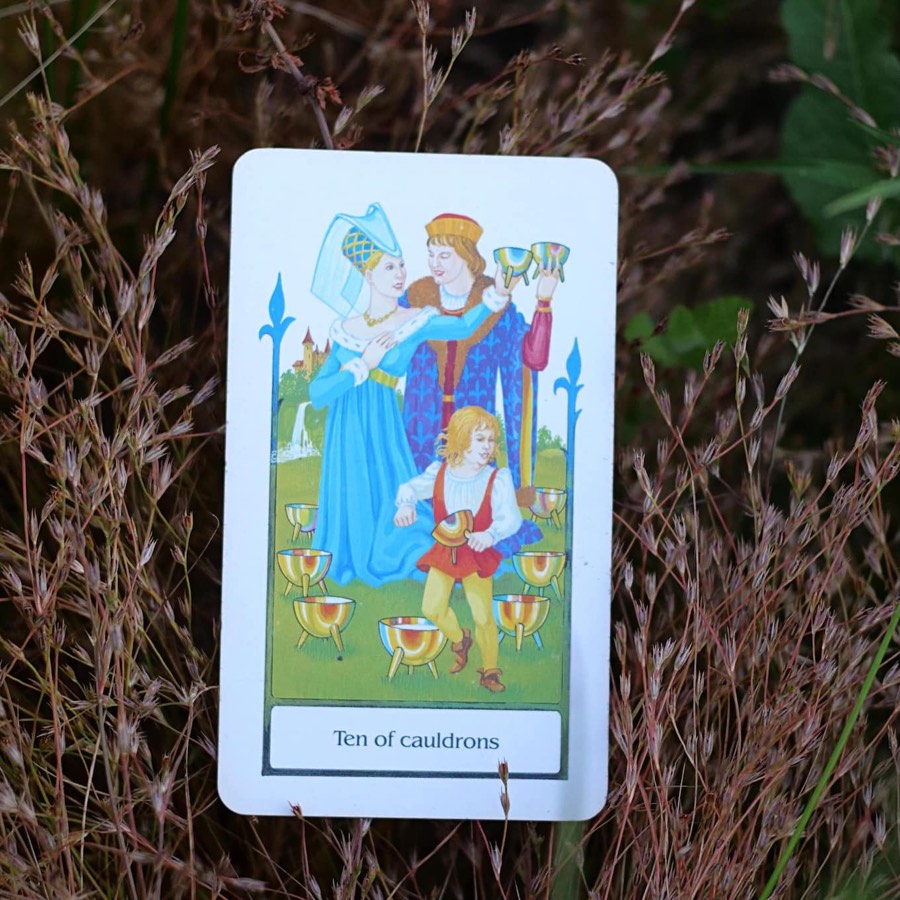 The Ten of Cups tarot card photographed outdoors