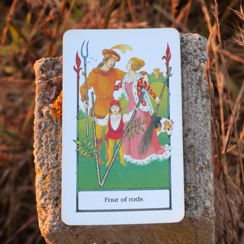 Four of Wands tarot card, photographed outdoors