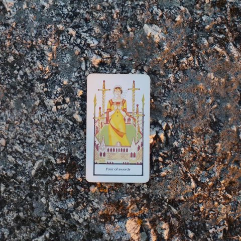 Four of Swords tarot card, photographed outdoors